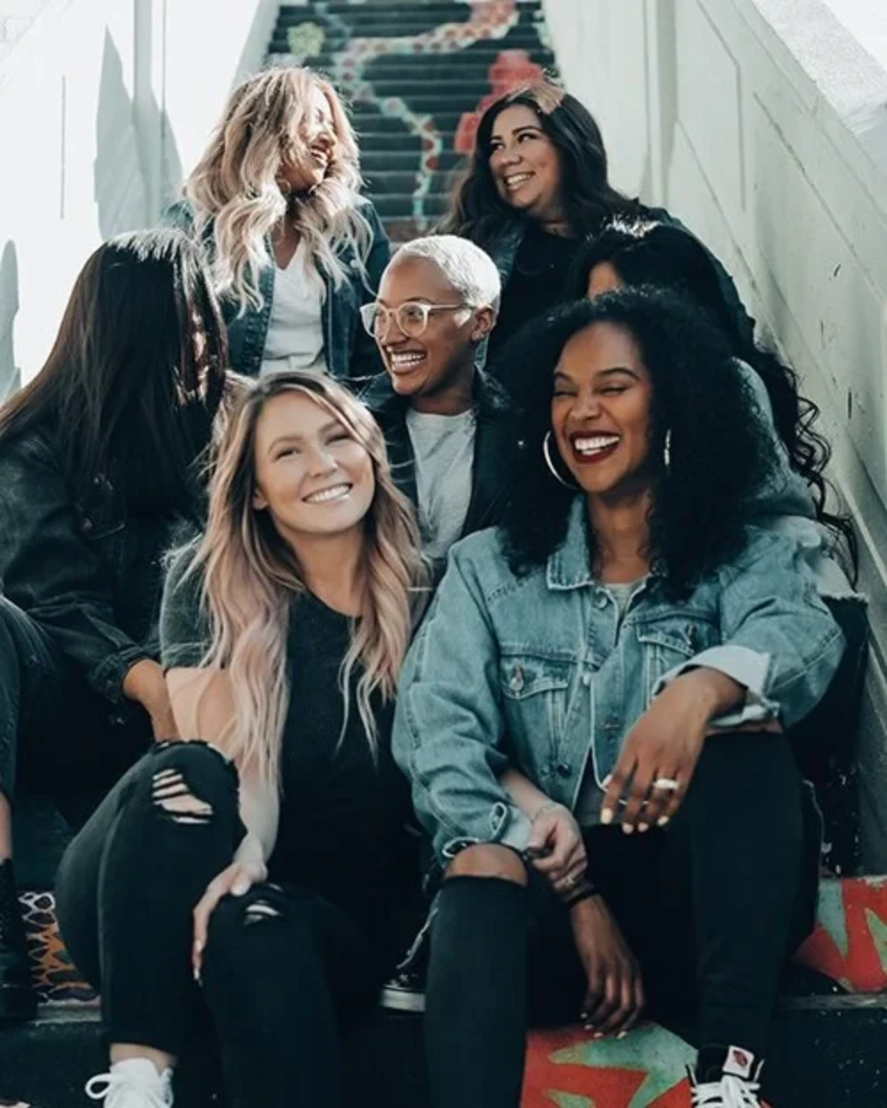 A diverse group of women smiling.